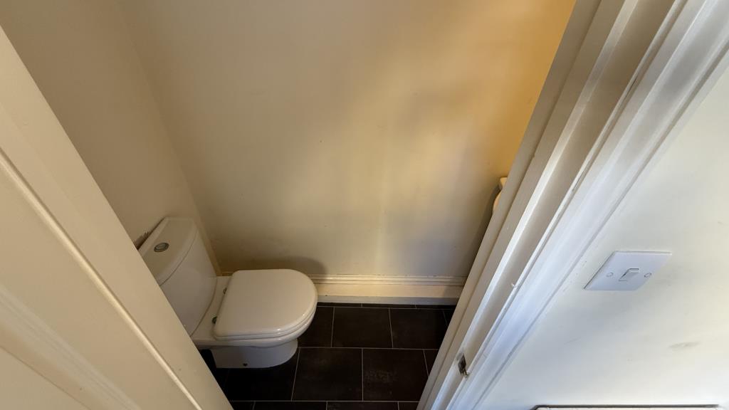 Lot: 133 - VACANT END-TERRACE HOUSE - Inside image of WC from lobby